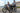 Couple riding Euphree City Robin X+ e-bikes along a seaside promenade, enjoying urban adventure and outdoor exploration.